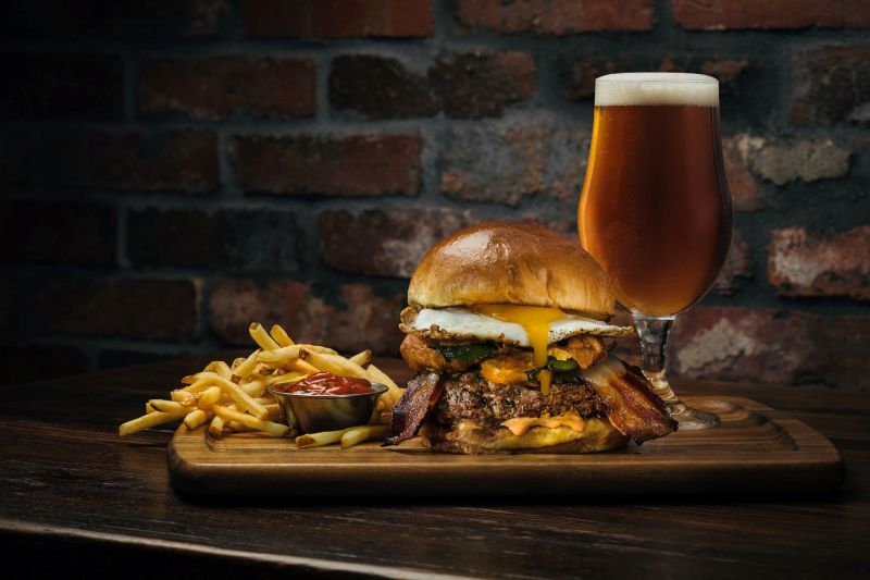 Jalapeño egg burger with fries and beer (Finney’s Crafthouse brand photo)