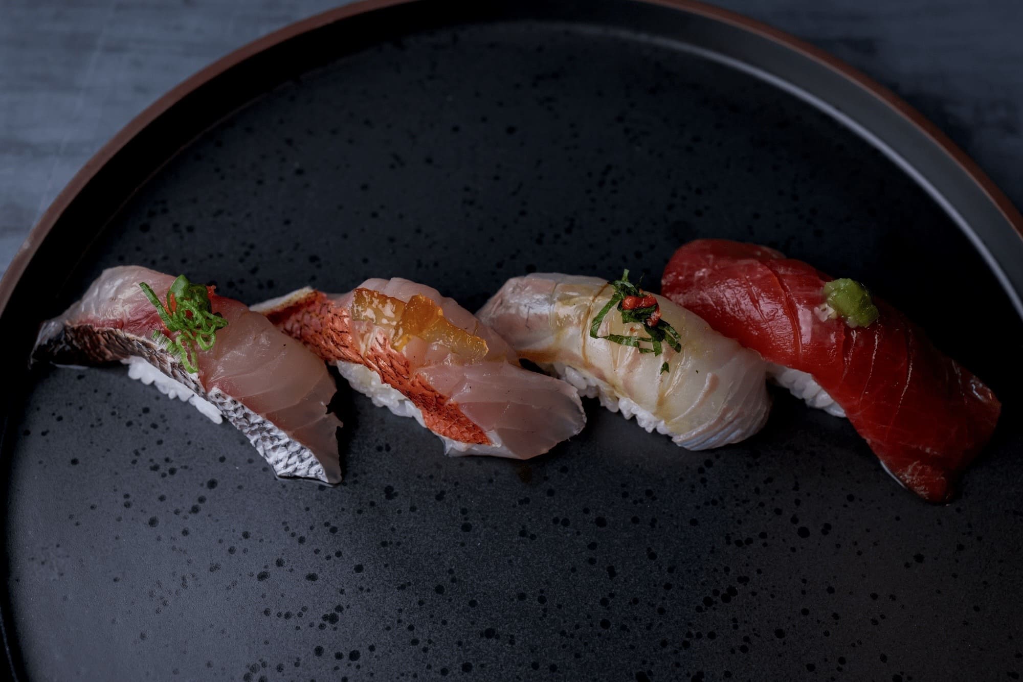 Nigiri / sushi plated at Glass Box (official brand photo)