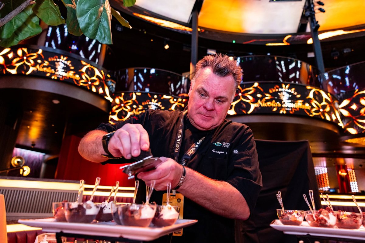 A chef plating small bites at a tasting table (official Rio photo)