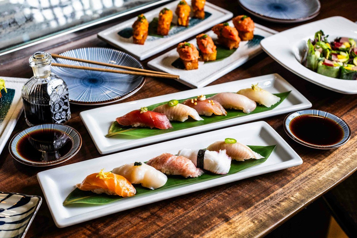 Plates of nigiri and sushi rolls on a bar top at Sushi Roku (official photo)
