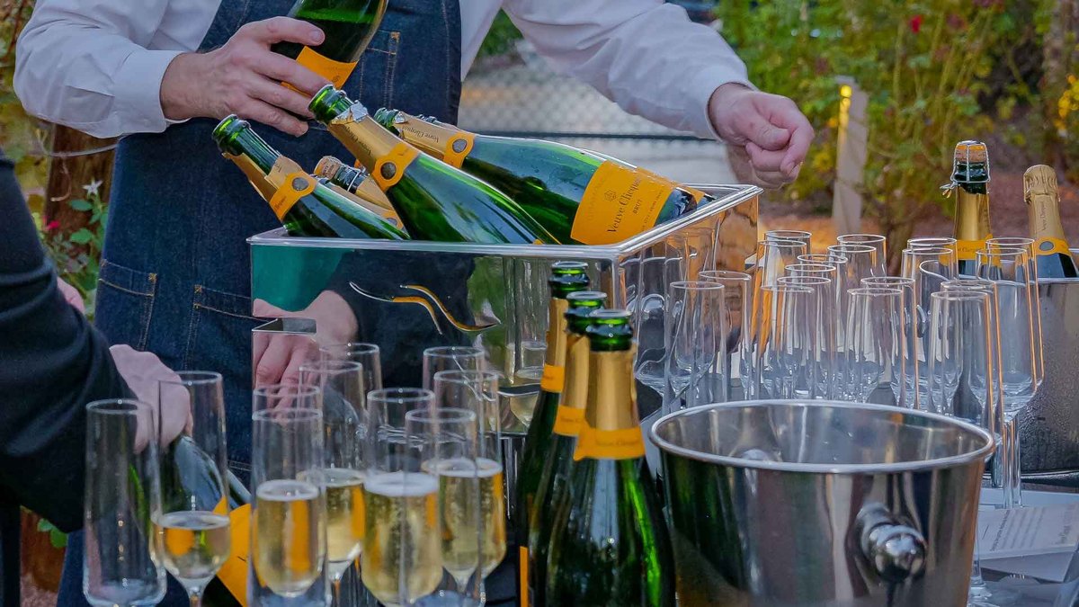 A server pours sparkling wine into rows of flutes at Green Valley Ranch’s wine tasting (official photo)