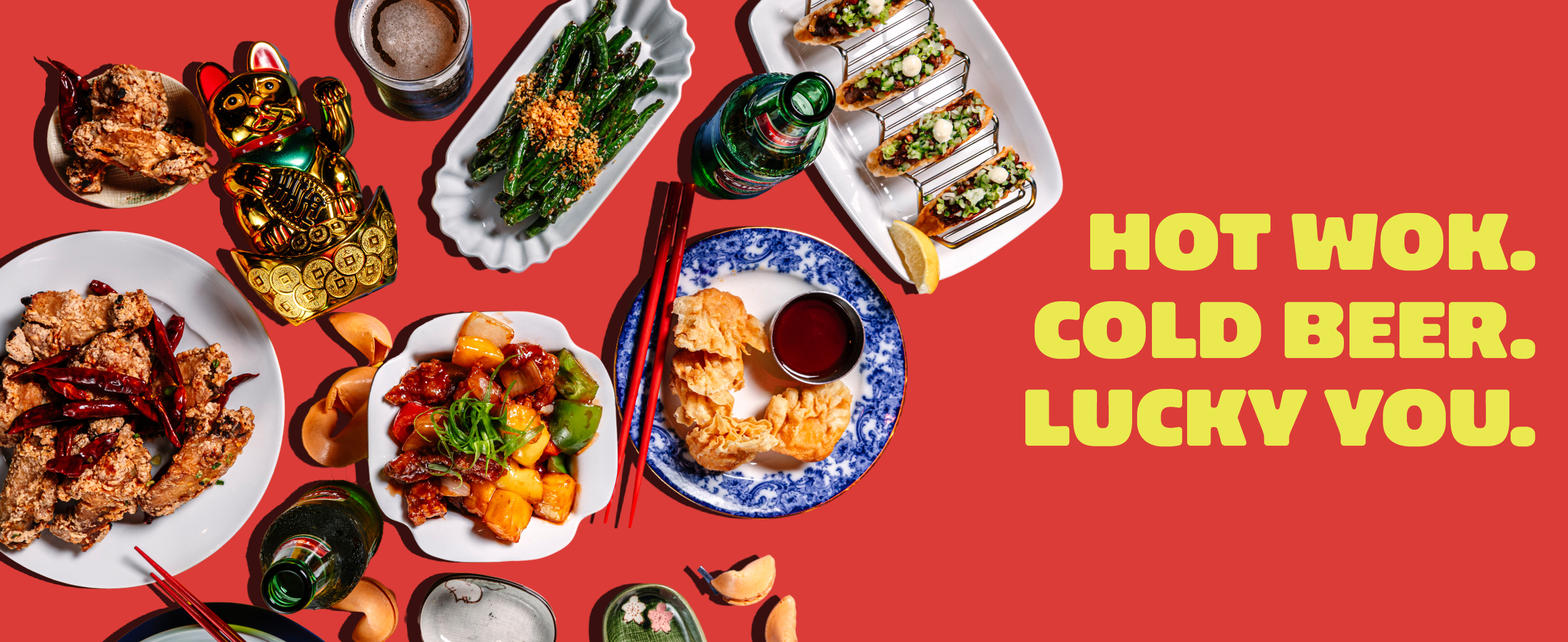 Chinese-American dishes, Tsingtao beers and a lucky cat on a red background with the words Hot Wok. Cold Beer. Lucky You. (Virgin Hotels graphic)