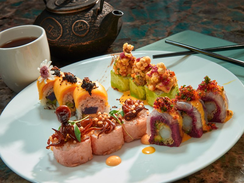 A plate of colorful specialty sushi rolls topped with sauces and fish roe (The Resort at Summerlin photo)