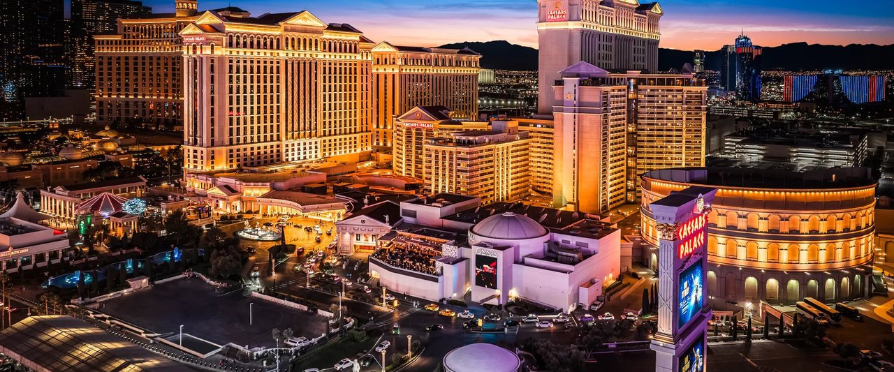 Aerial view of Caesars Palace lit up at dusk on the Las Vegas Strip (Caesars Entertainment photo)